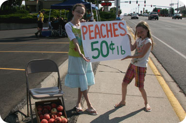 Girls selling peaches